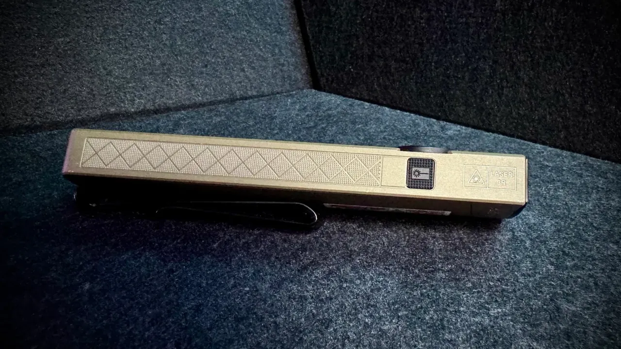Opposite side profile of the ArkPro Ultra showing the dedicated recessed laser button and the engraved 'LASER 3R' safety marking next to the laser hazard symbol